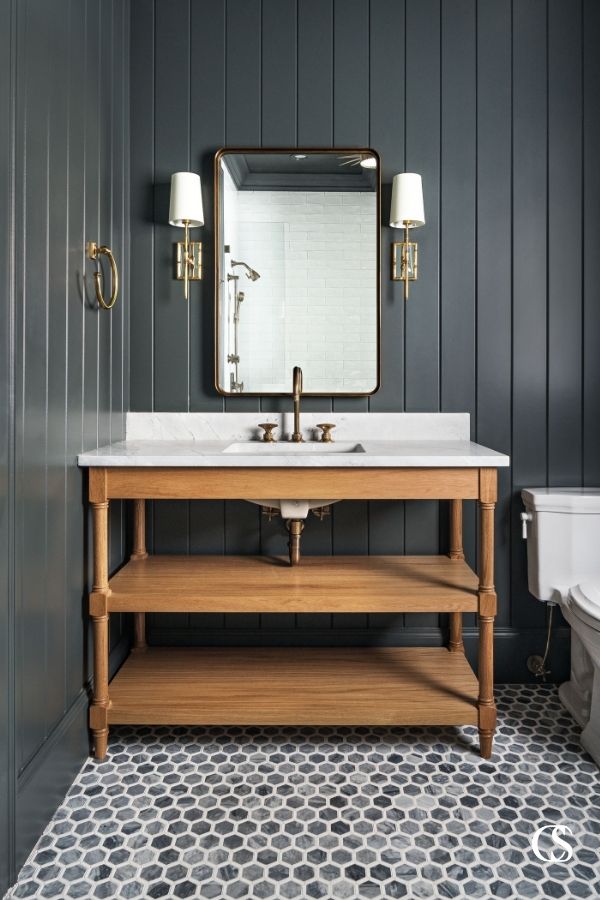 There is something about the combination of the black slat walls, hex tile flooring, and open shelf custom bathroom cabinet that make this room feel perfectly retro modern.