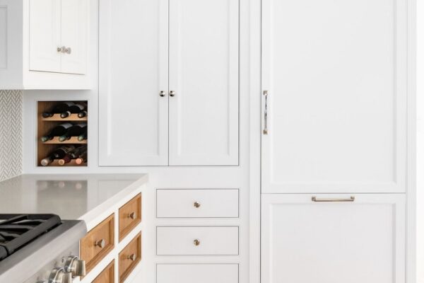 Who says every drawer and cupboard door have to match? These kitchen cabinet doors feature contrasting stained wood against the rest of the white painted cabinets, to great effect!