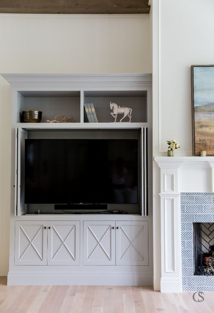 A custom built in entertainment center can be crafted to hide and store your electronics with custom bi-fold cabinet doors like this. Close the doors and you’ve got a beautiful living room.