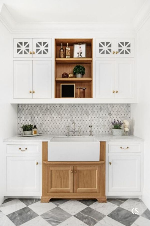 Every one of the symmetrical, angular patterns in this custom cabinetry design makes it perfectly unique and worth standing over the sink for.