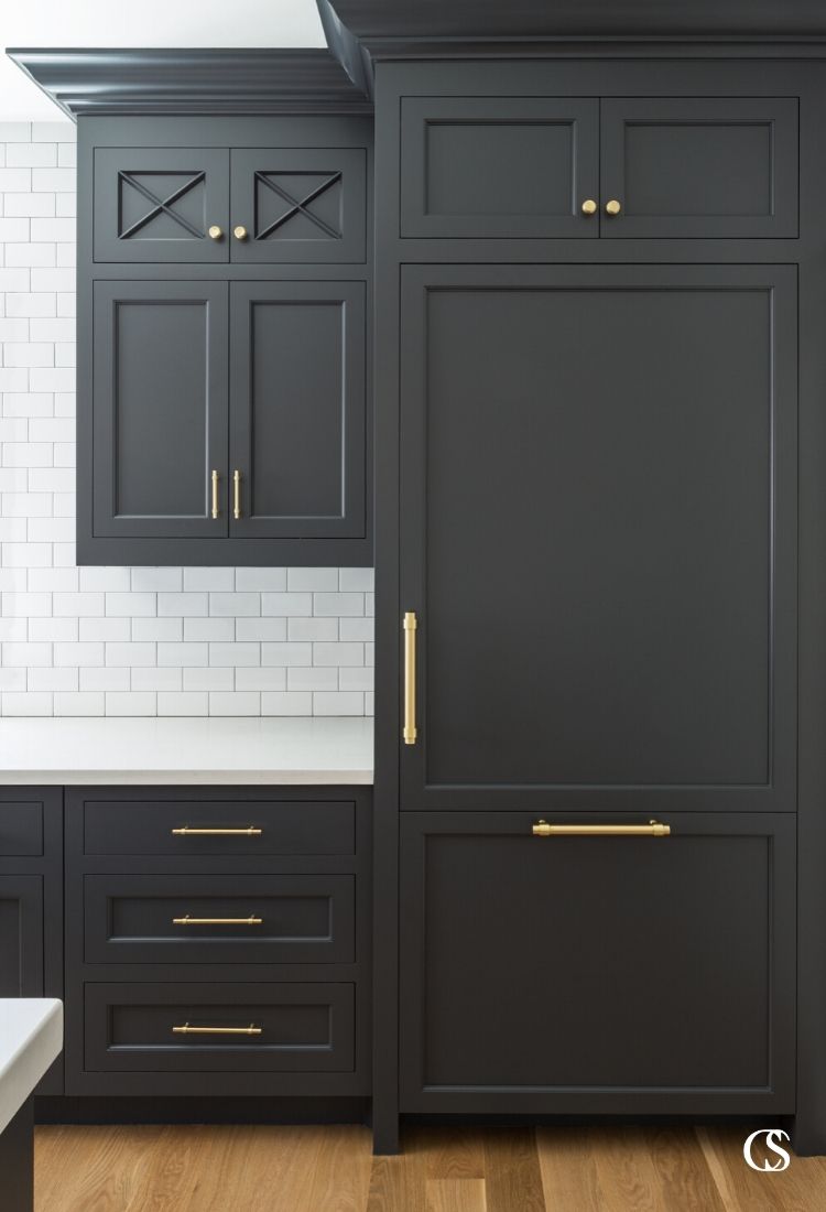 The flat panel cabinet doors in this black kitchen cabinet design create a timeless effect in a three tone kitchen.