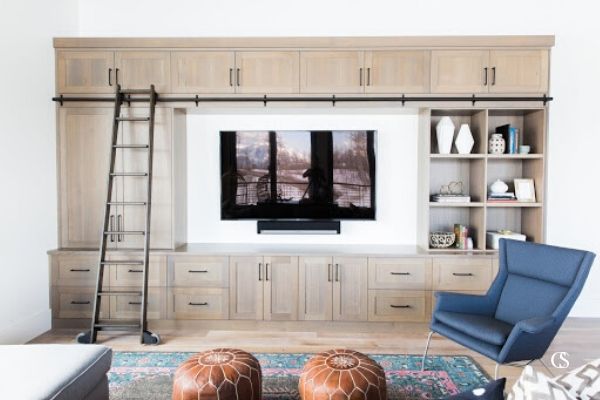 This wall to wall custom entertainment center uses every inch of available space, but makes it easy to reach with a built in ladder. For more ideas for your home, visit ChristopherScottCabinetry.com!