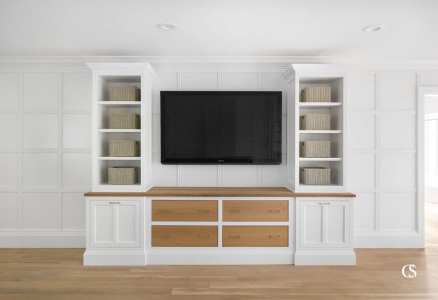 Open shelving is the perfect way to bring lightness to a big entertainment center, but it doesn't mean everything has to be on display. For more of our best entertainment center ideas, check out ChristopherScottCabinetry.com!