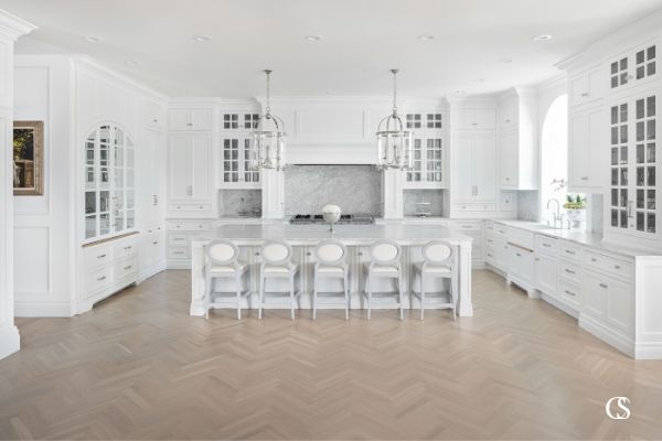 Need island ideas for the kitchen? This white custom kitchen is full of so many custom design touches that give it a luxurious feel and that island is big enough to fit a crowd!