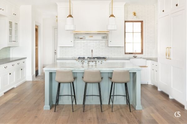 Love the idea white paint for your kitchen cabinets but want to add a pop of color? A custom kitchen island is the perfect place to bring a little color to your white space!