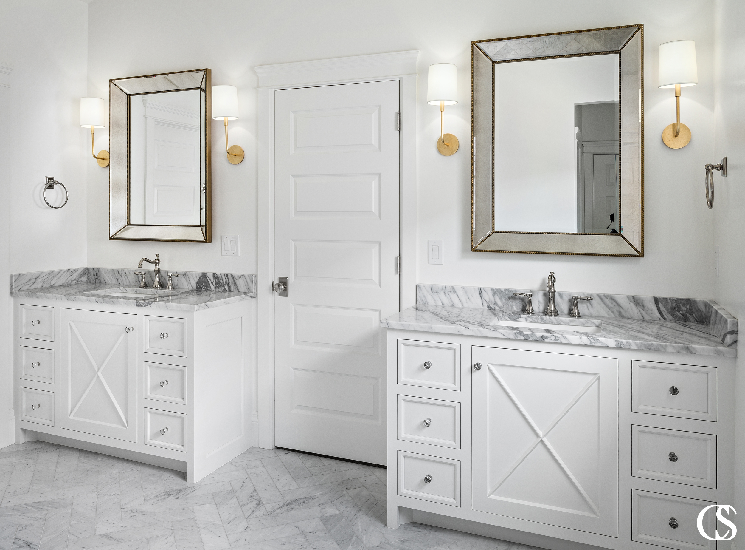 Custom bathroom cabinet design can combine multiple aesthetics, like the modern and farmhouse looks you see coming together in these matching bathroom vanities.