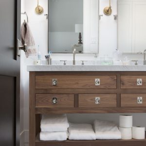 Slab front drawers, distinctive hardware, clean lines...what vanity dreams are made of! This unique custom bathroom cabinet pulls off a look completely different than most bathroom vanities—that's what working with professional cabinet designers will get you.