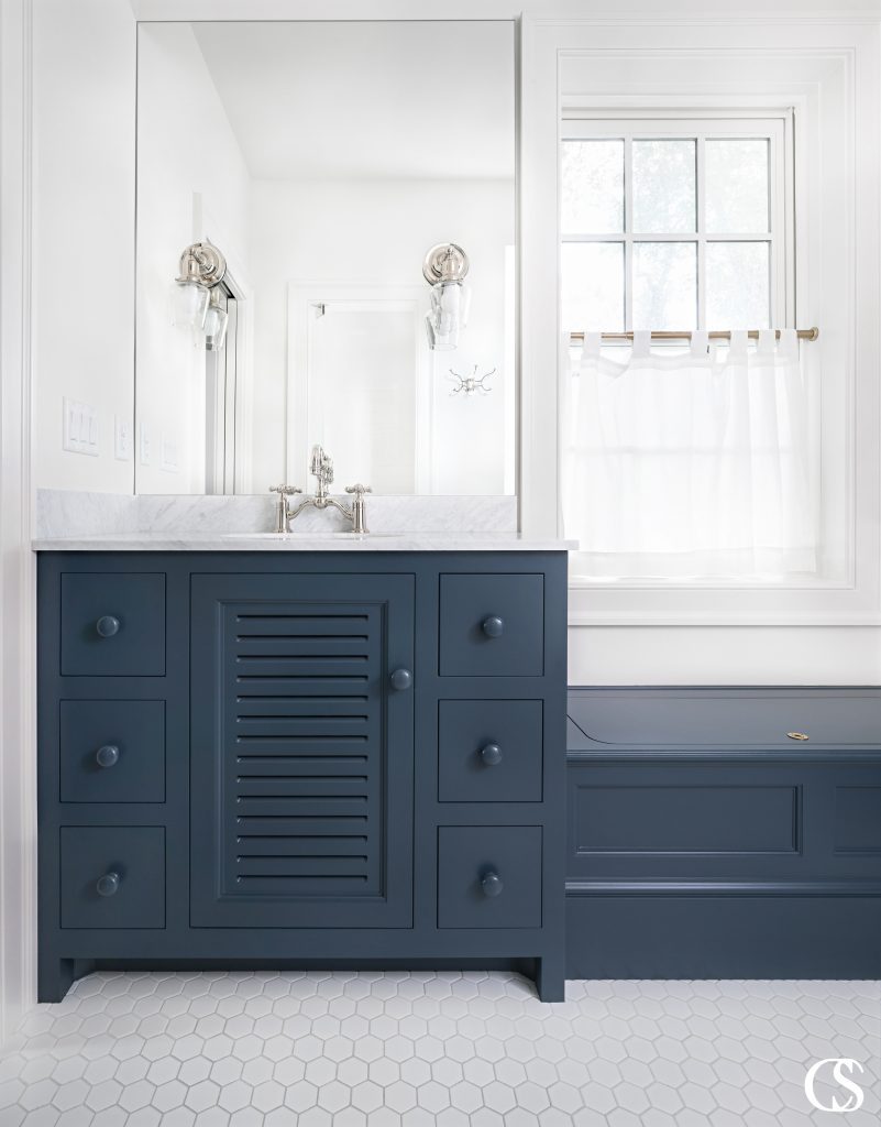 What could become a bulky bathroom cabinets design is completely changed by the slats in the center cupboard door. It's the little decisions like that which take custom cabinetry to the next level.