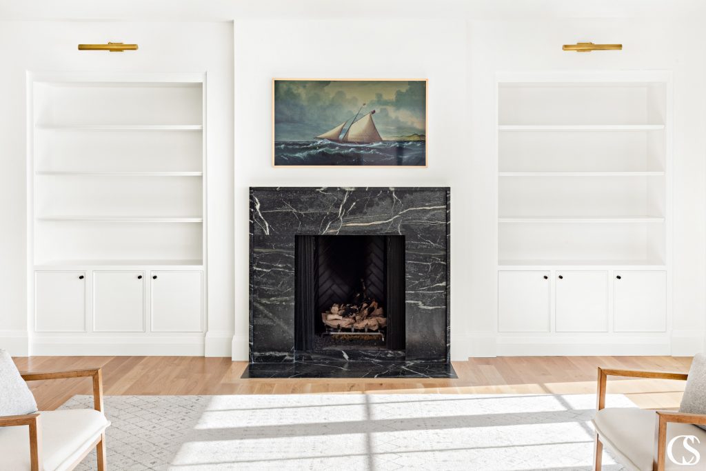 Designing custom cabinets for the home often means making them feel like they belong, like they've always been part of the house plans—like these sleek built-in cabinets flanking the marble fireplace.