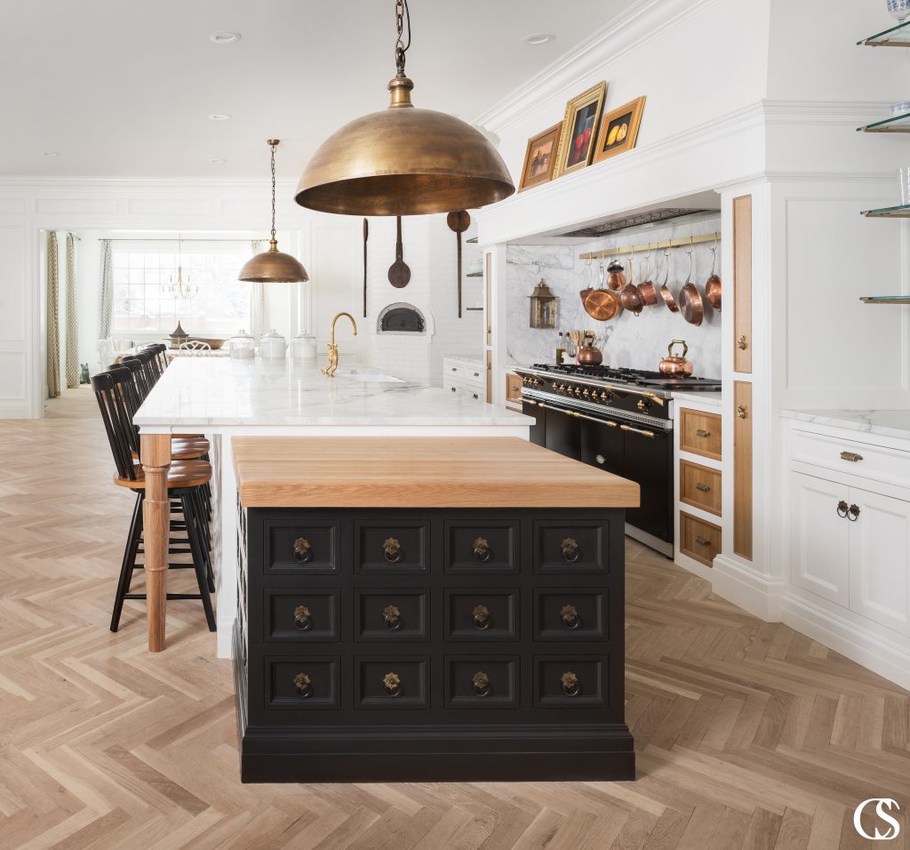 Beautiful custom black kitchen cabinets can have a powerful impact on your home. This unique kitchen island design combines multiple colors, materials, and global influence to reflect a beautifully eclectic style.