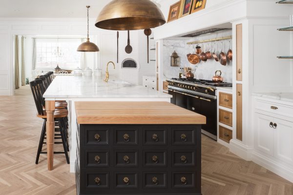 Beautiful custom black kitchen cabinets can have a powerful impact on your home. This unique kitchen island design combines multiple colors, materials, and global influence to reflect a beautifully eclectic style.