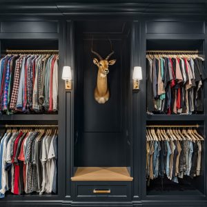 Don't ever think that custom built in cabinet closet design is just for the ladies. This man cave of a dream closet is moody and makes every hat, shirt, and pair of shoes pop.