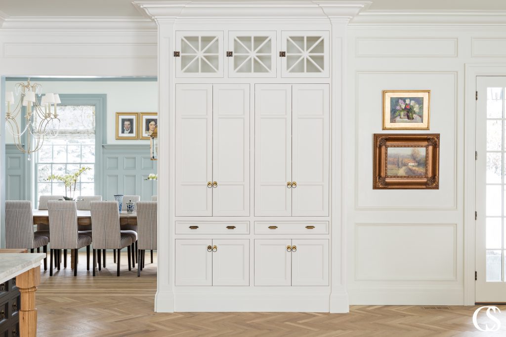 When you've created the best built in custom cabinet, you don't want to hide it. This one provides all the eye candy necessary between the kitchen and formal dining area.