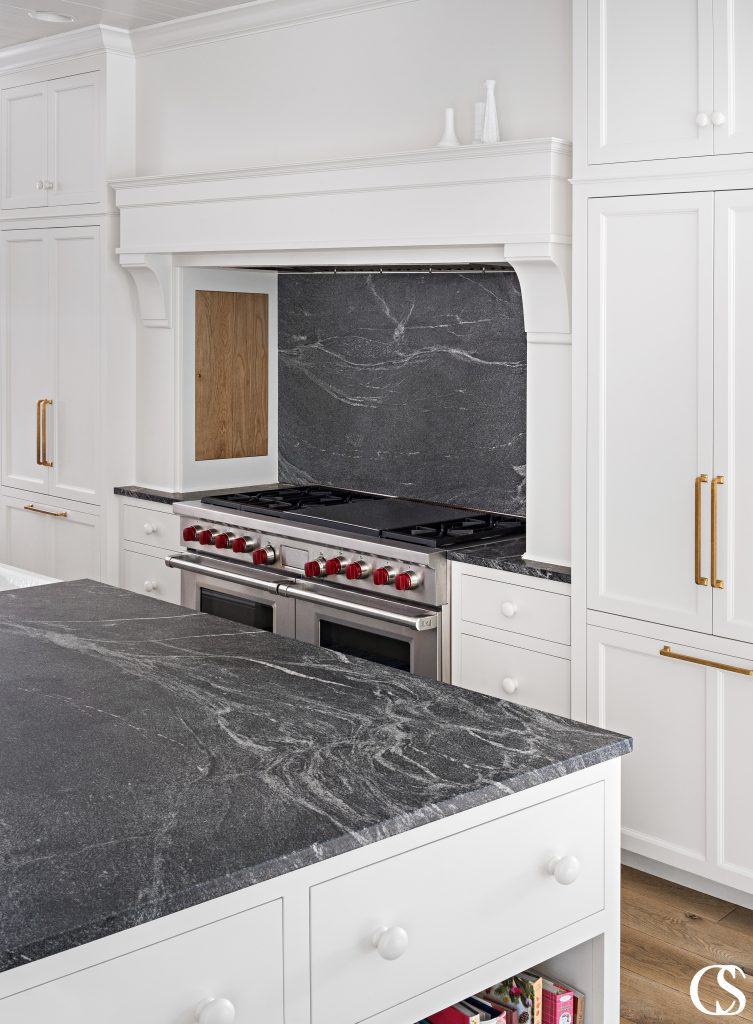Some of the best custom cabinet design in the kitchen comes complete with a hidden spice cupboard near the stove for easy access during cooking and beautiful kitchen storage.