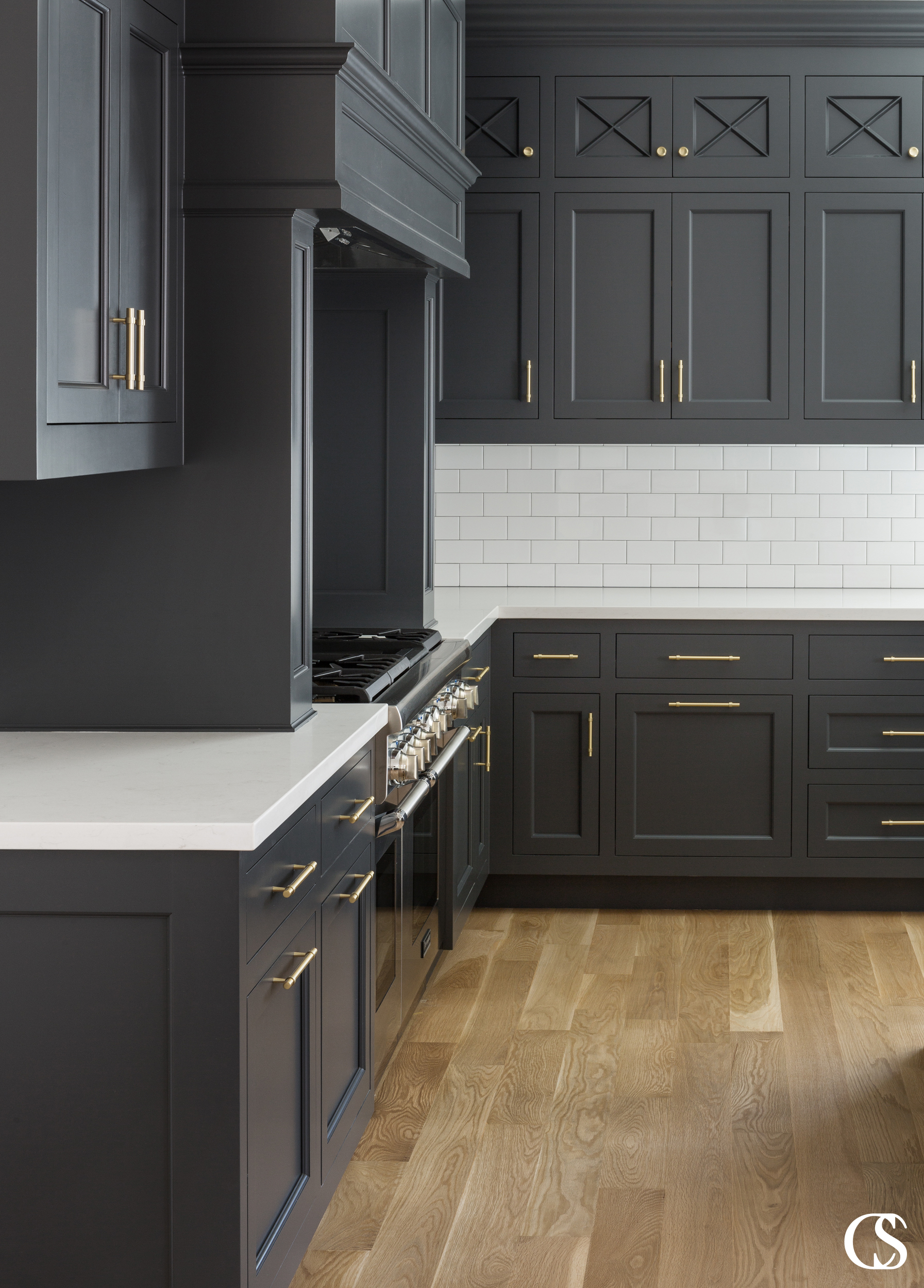 The combination of just the right black paint, perfectly mixed cupboard and drawer faces, and beautiful hardware make this some of the best custom cabinet design for the kitchen we've created.