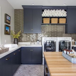 I love this laundry room! One, for its moody take on a household task and two, because it has some of the best design ideas for cabinets in the laundry room—like pull out cabinets for each family members' clothes hamper!