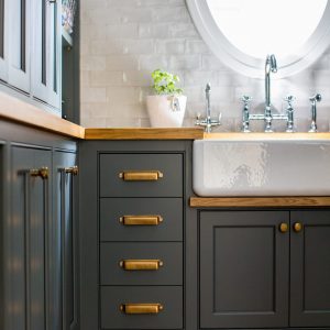 The best kitchen pantry design ideas are ready for anything kitchen prep can throw at them. A great custom pantry needs an array of drawers, cabinets, shelving, and a great farmhouse sink. And why not add some deep paint, just to throw it over the top?