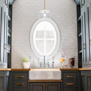 The best kitchen pantry design ideas are ready for anything kitchen prep can throw at them. A great custom pantry needs an array of drawers, cabinets, shelving, and a great farmhouse sink. And why not add some deep paint, just to throw it over the top?