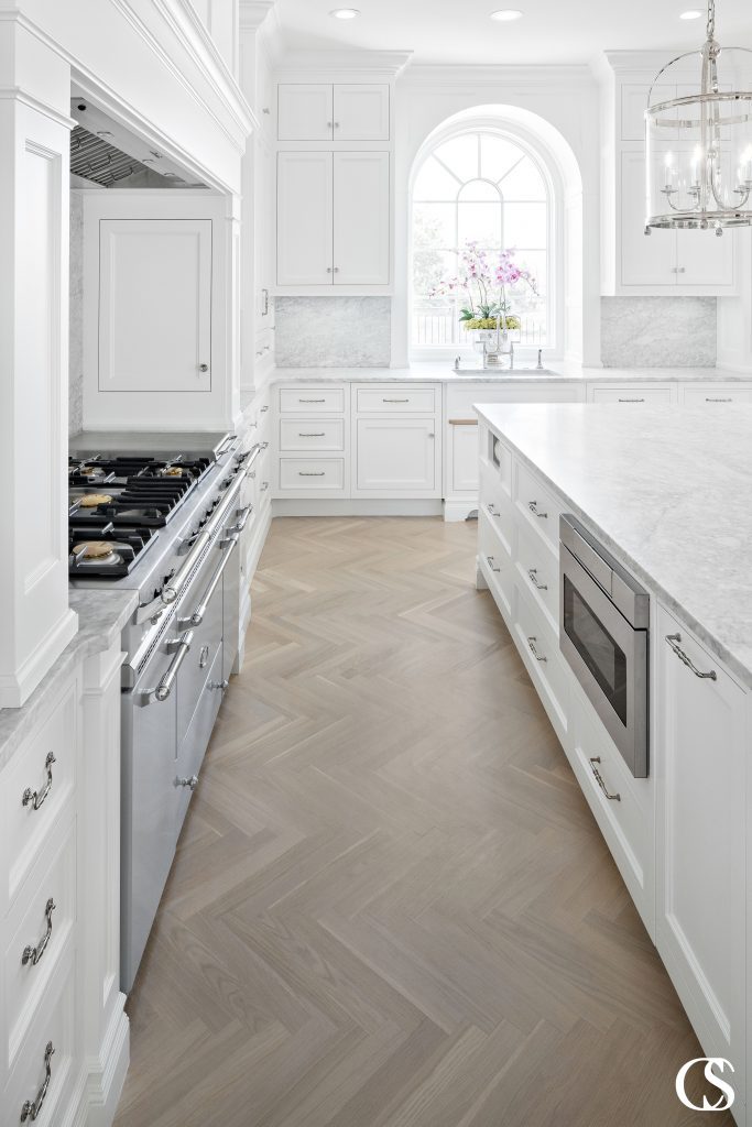 Some of the best white kitchen designs will utilize all the natural light they can to keep it feeling bright, open, and clean.