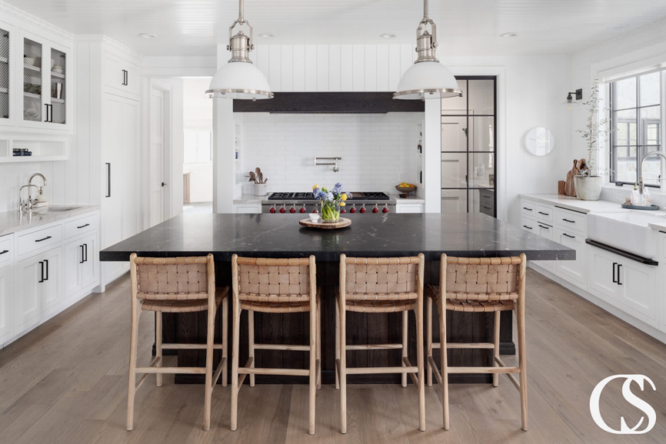 Black kitchen island with ample storage and seating, perfect for a modern and sleek kitchen design.