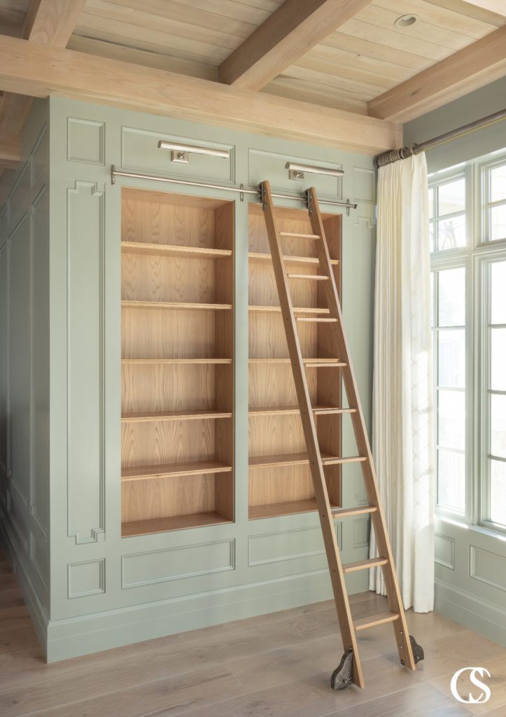 The ladder not only makes the upper shelves accessible in this bookcase, but it becomes a design element itself.