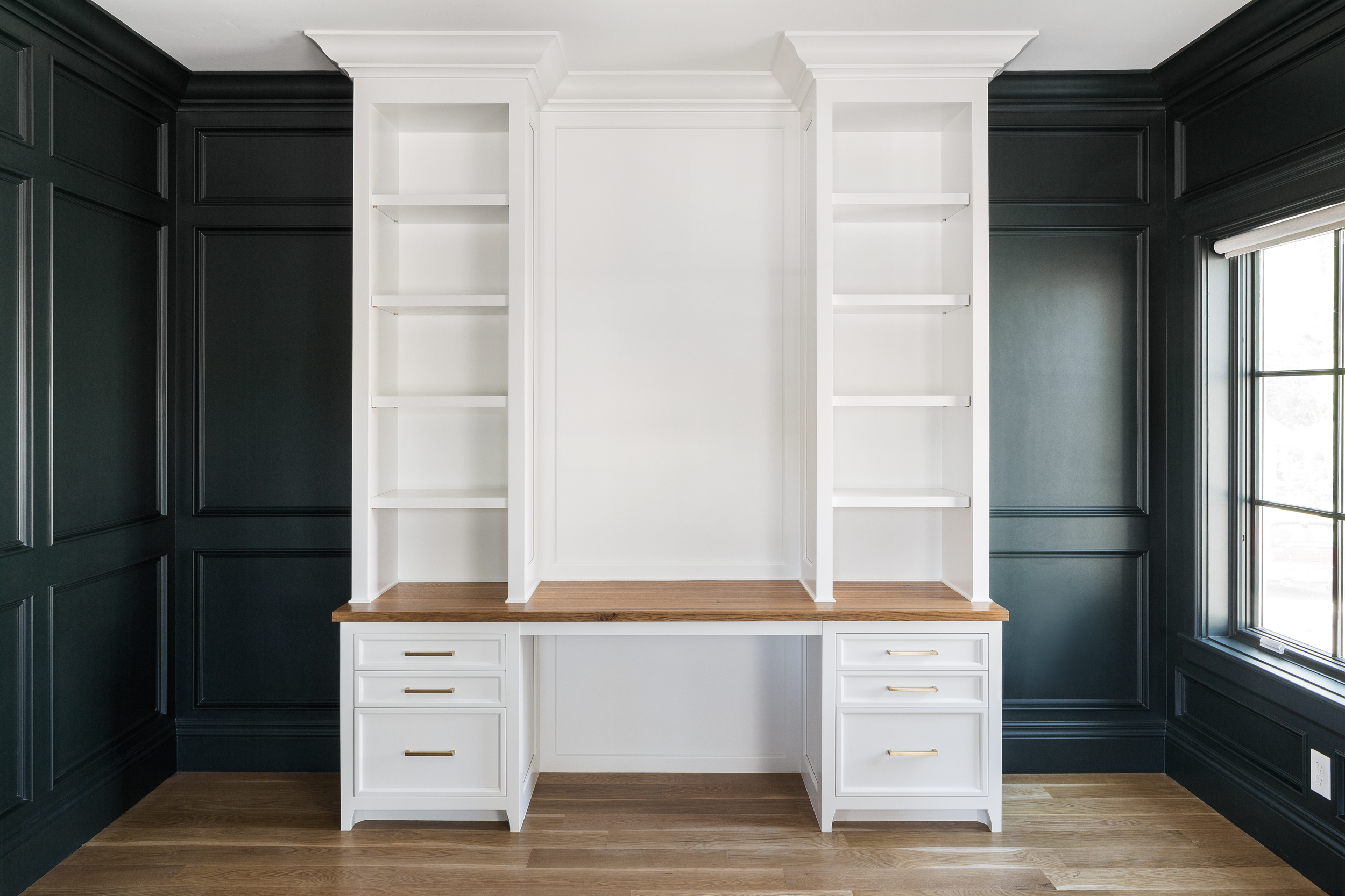 There is plenty of room for making a statement with built in desk designs. Like this white one that creates a great backdrop for working, but is nestled in a deep green office for maximum personality.