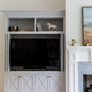 A custom built in entertainment center can be crafted to hide and store your electronics with custom bi-fold cabinet doors like this. Close the doors and you’ve got a beautiful living room.