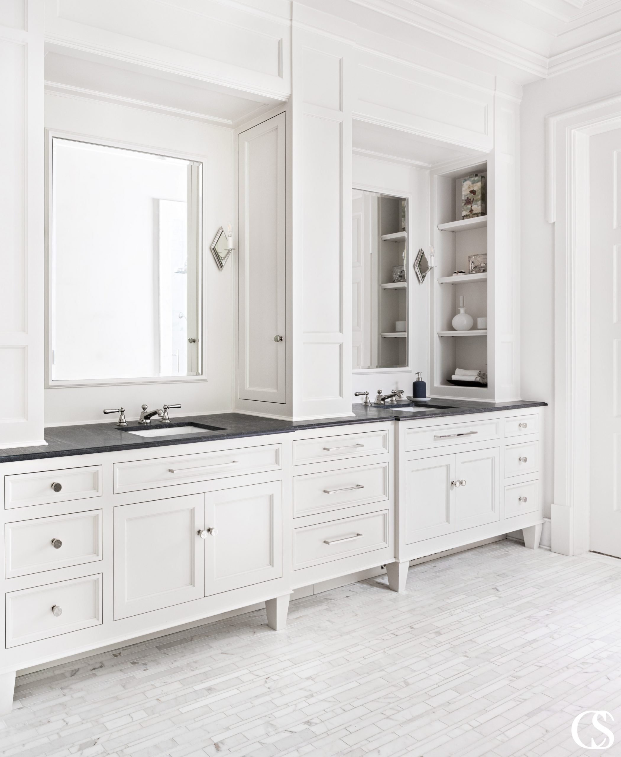 The white aesthetic is a complete classic. These custom bathroom cabinets play perfectly with a unique tile floor and large mirrors to create even more white space.