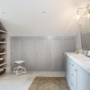 The locker-like custom bathroom cabinets in this space offer plenty of towel and paper product storage, as well as individual cubbies for the bathroom's users.