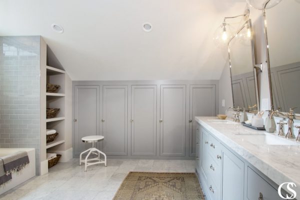 The locker-like custom bathroom cabinets in this space offer plenty of towel and paper product storage, as well as individual cubbies for the bathroom's users.