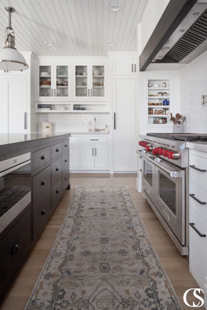 Stunning black kitchen island with a unique design and ample storage options, perfect for any kitchen looking to add a touch of elegance and functionality