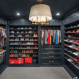 Don't ever think that custom built in cabinet closet design is just for the ladies. This man cave of a dream closet is moody and makes every hat, jacket, and pair of shoes pop.
