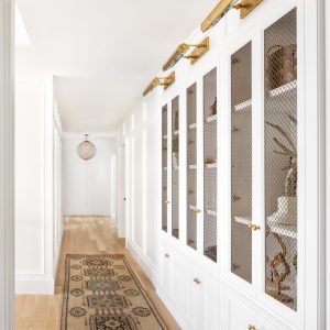 Make a hallway more than just bare walls and doorways with custom built in design like this! It's a beautiful way to create space and add character to a home.
