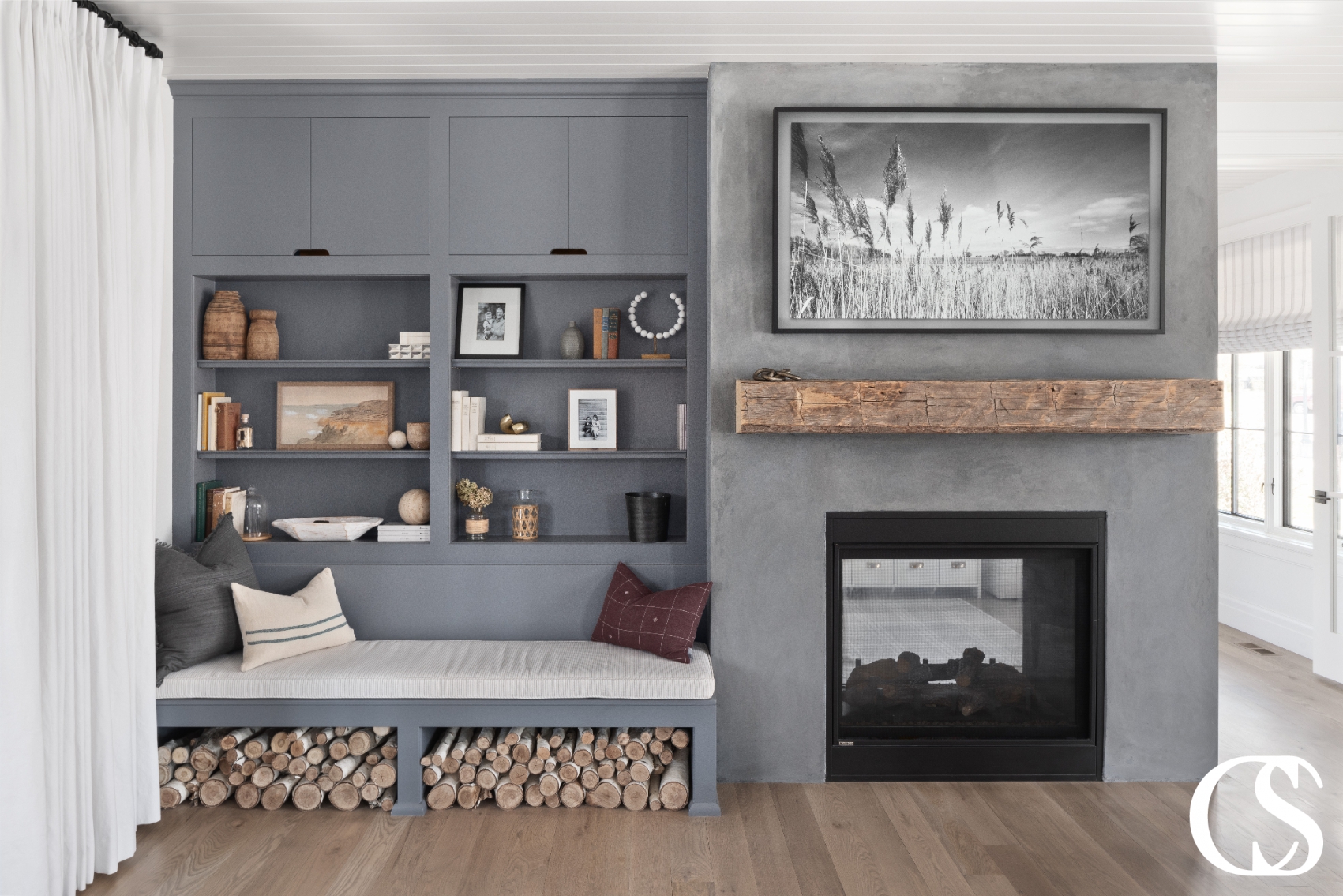 Functional and stylish custom built-in cabinets, designed to maximize storage while fitting seamlessly into the overall design of the room. The cabinet features a mix of open shelving and closed storage options with a gray paintedfinish.