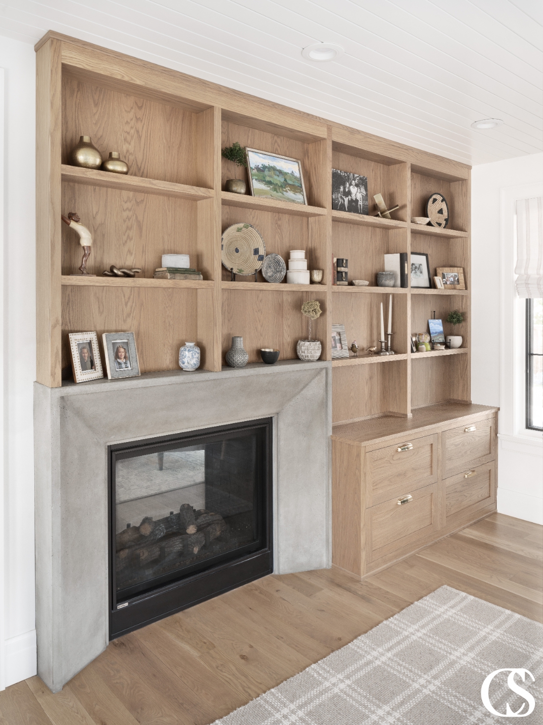 Custom built-in cabinets designed to provide ample storage space while fitting seamlessly into the architecture of the room, featuring a warm wood finish