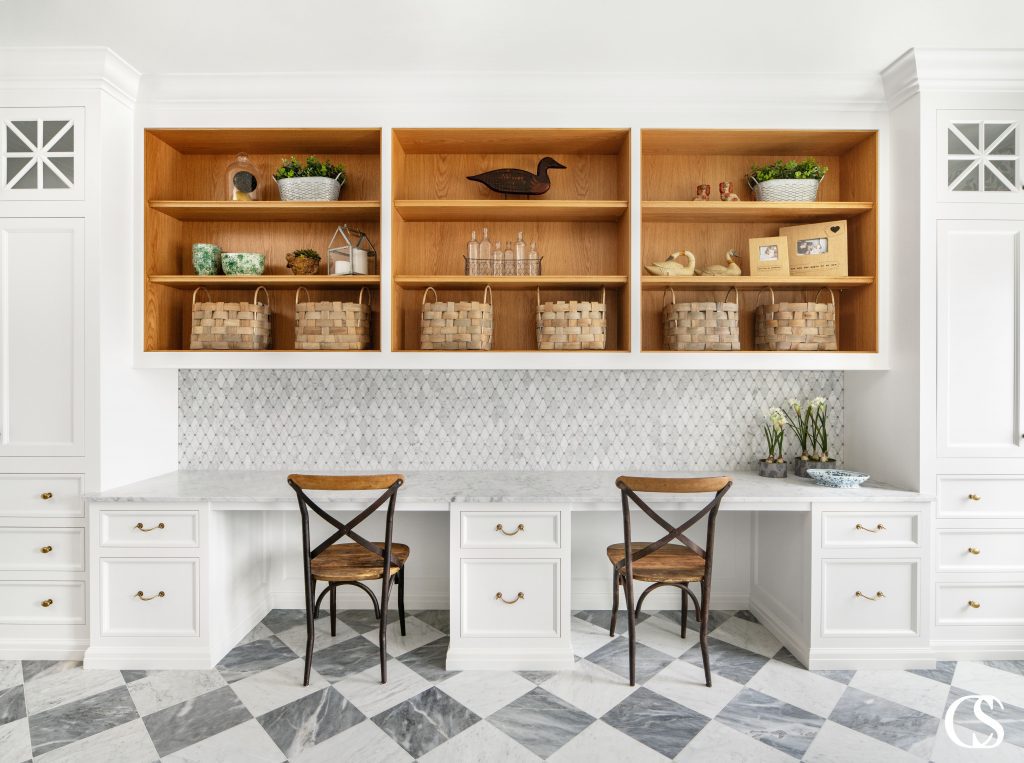 Don't think that custom cabinetry ends in the kitchen or living room. Why not add a set of built in desks and upper shelves to really take your laundry room to a beautifully designed multi-functional space.