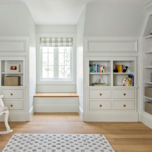 Commissioning custom cabinets for your home means fitting exactly what you need, where you want it. Like these custom nursery cabinets with their perfect tiny window seat for snuggling up and reading together.
