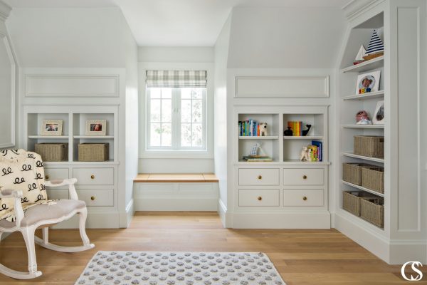 Commissioning custom cabinets for your home means fitting exactly what you need, where you want it. Like these custom nursery cabinets with their perfect tiny window seat for snuggling up and reading together.