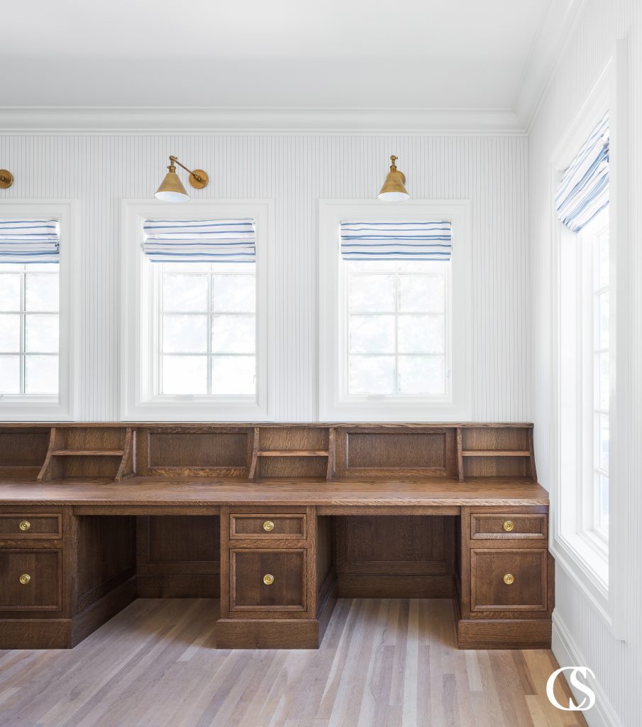 If you have more than one child, creating custom cabinets for a home office might mean multiple desks. This custom built in desk creates those necessary separate spaces, but with one continuous worktop for unimpeded design flow.