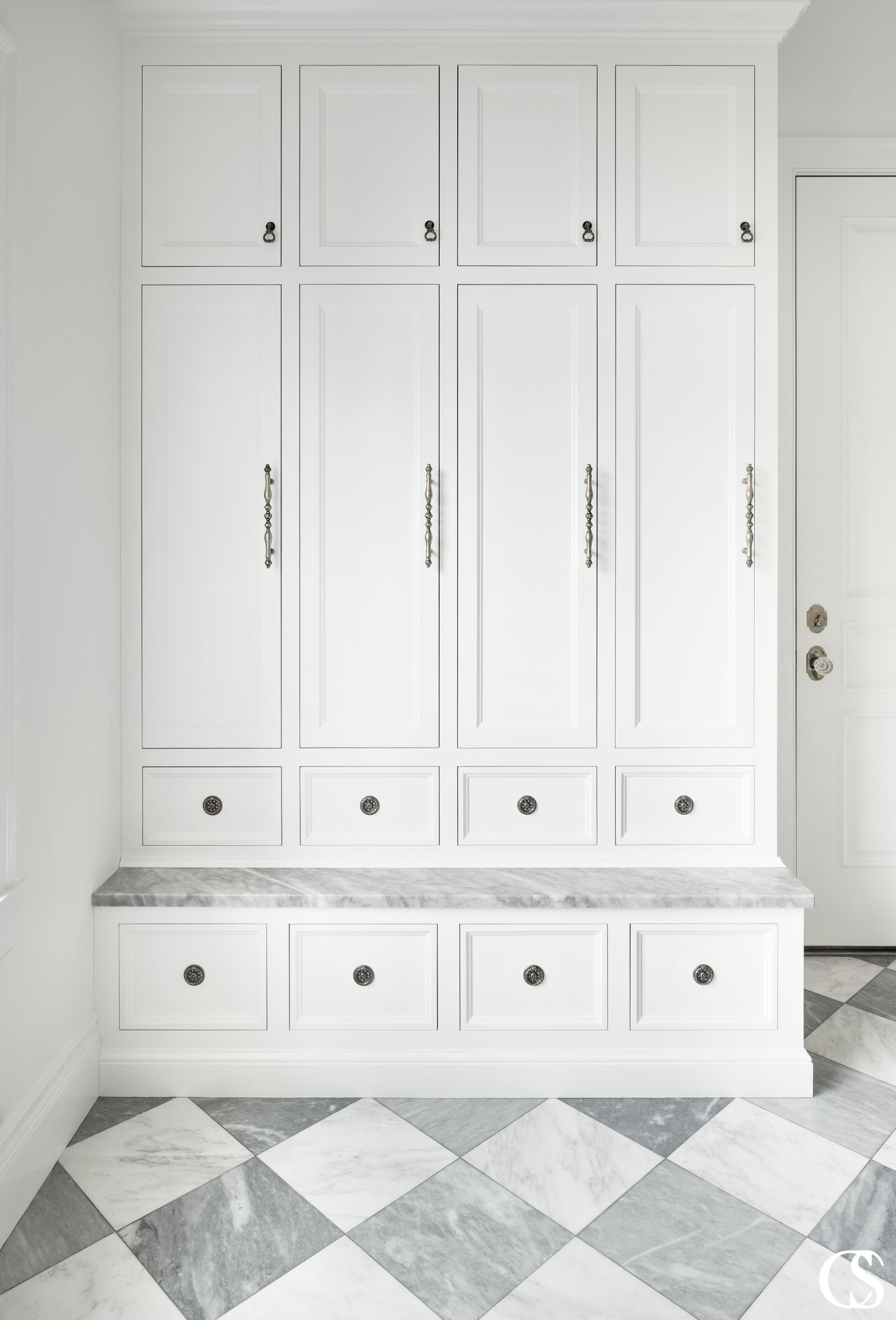 This classic mudroom design utilizes locker-like custom cabinets with a bench for the ultimate storage solution in a small space.