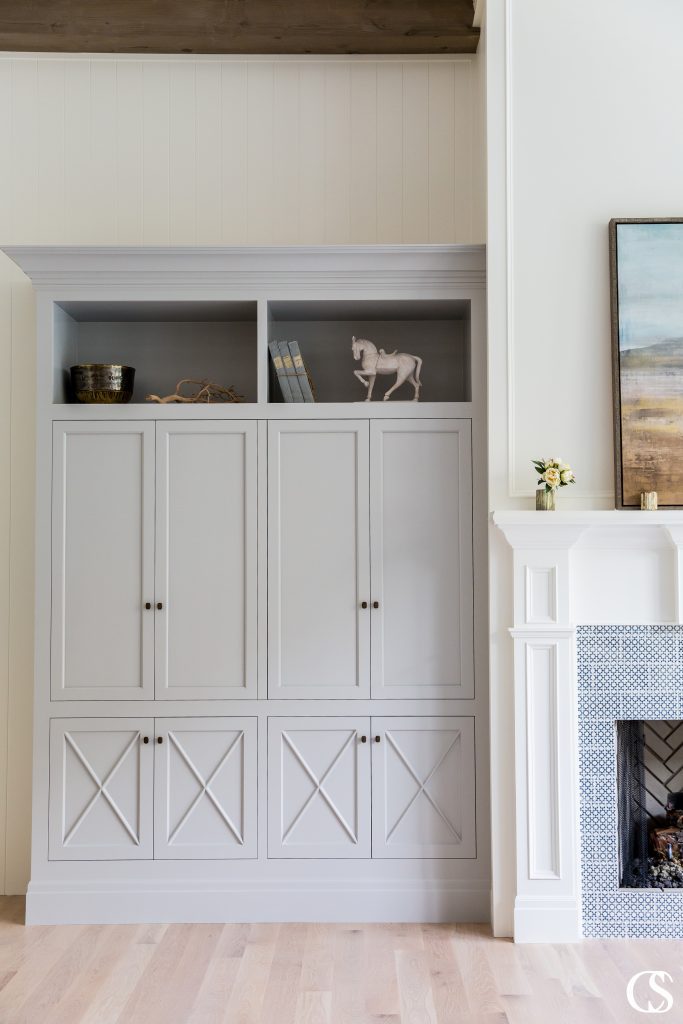 A custom built-in entertainment center can be crafted to hide and store your electronics with custom bi-fold cabinet doors like this. Close the doors and you’ve got a beautiful living room.