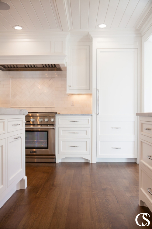 I love the way this custom kitchen cabinet design transitions seamlessly into a shiplap-style ceiling.