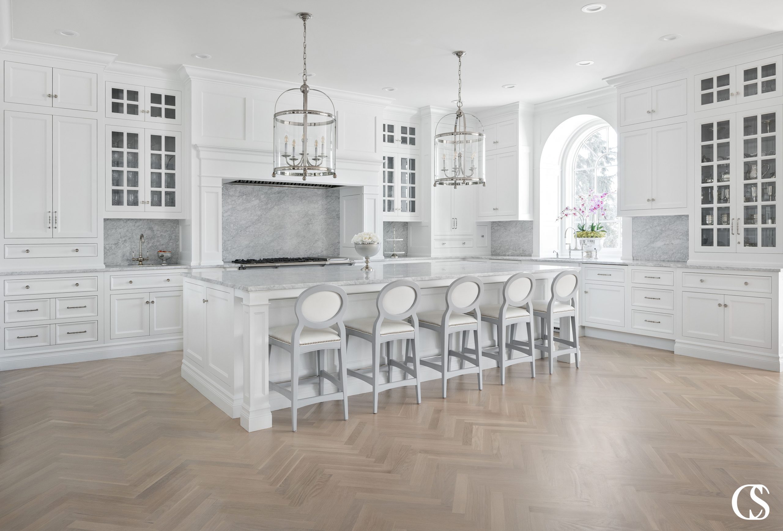 This white kitchen island design creates an anchor for this large room to stay grounded.