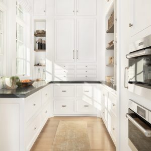 What kitchen pantry design ideas are running around in your head? This pantry sings of organization with a combination of open shelves, usable counter space, and beautiful custom inset cabinetry.