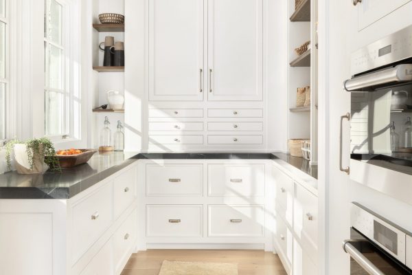 What kitchen pantry design ideas are running around in your head? This pantry sings of organization with a combination of open shelves, usable counter space, and beautiful custom inset cabinetry.