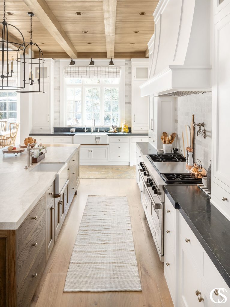 The natural woods in this white custom kitchen brings a certain homey balance to the space. It's cozy yet bright and clean.