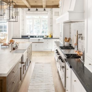 The natural woods in this white custom kitchen brings a certain homey balance to the space. It's cozy yet bright and clean.