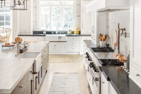 The natural woods in this white custom kitchen brings a certain homey balance to the space. It's cozy yet bright and clean.