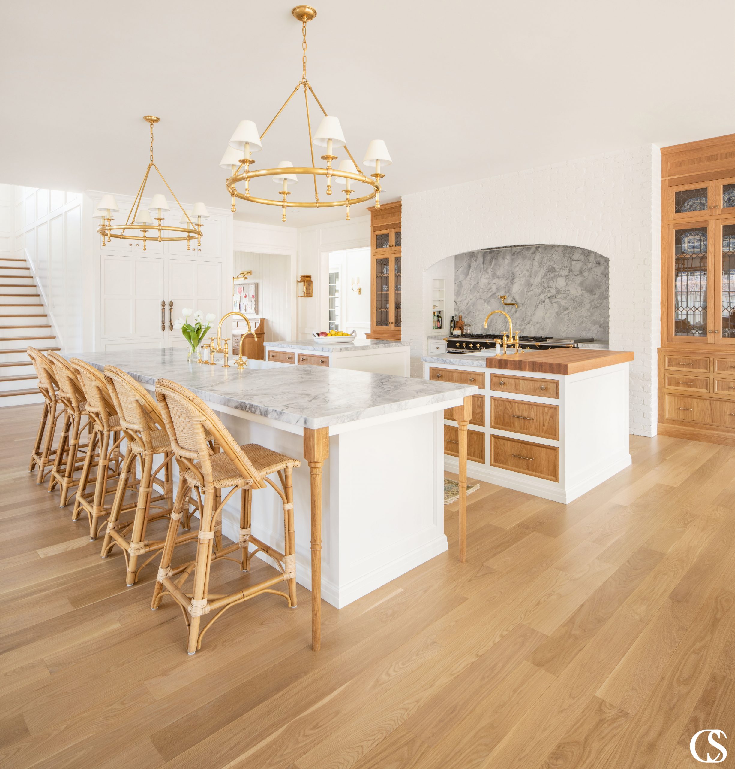 A white kitchen doesn't have to mean anything is stark. This custom kitchen design utilizes warm stained wood to bring life to the kitchen cabinets and completely unique flair to the white and wood kitchen.