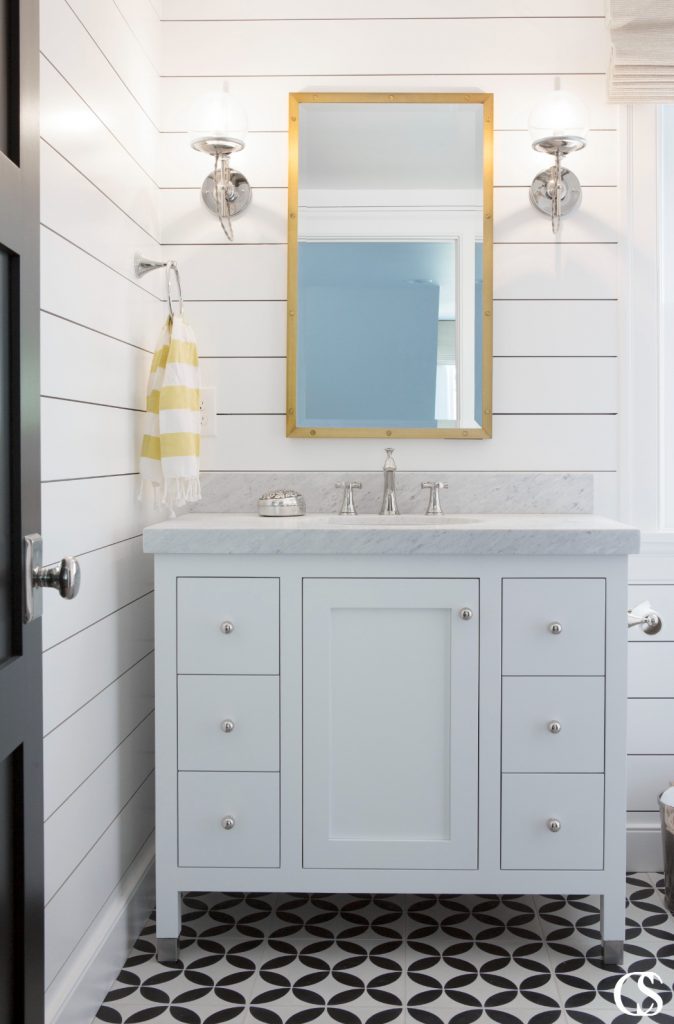 While many small bathrooms only have a sink with a cabinet below, this setup incorporates two columns of drawers, which are extremely valuable in a bathroom.